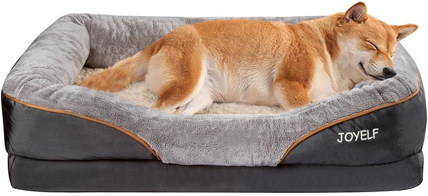 Dog sleeping comfortably on a plush gray dog bed with raised sides.